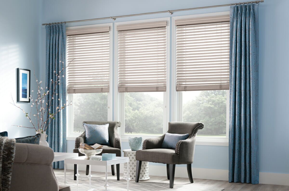 Simple, sturdy blinds pair nicely with patterned drapes for a clean and elegant look.
