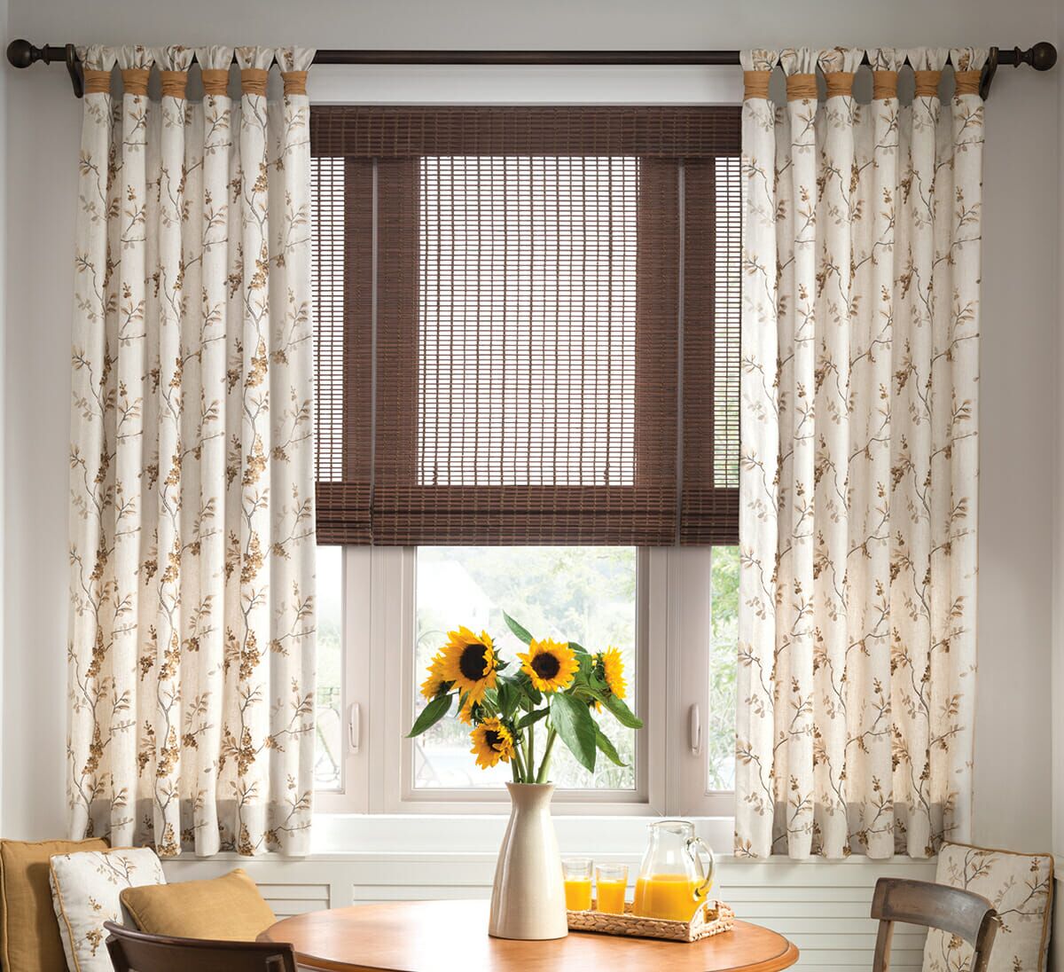 Fabric drapes create contrast with woven wood shades