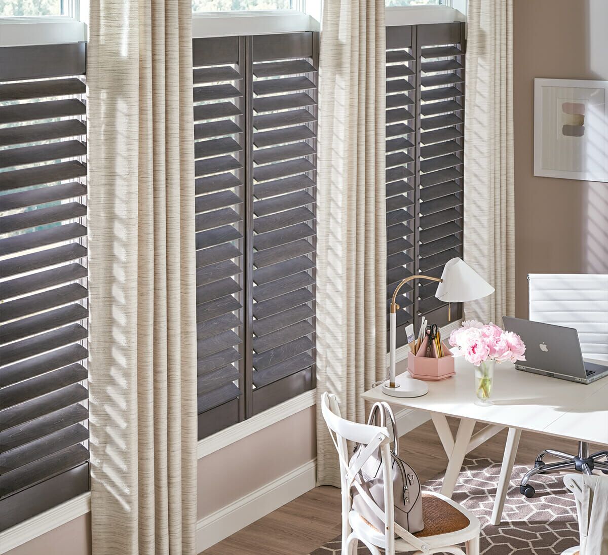 Pairing classic shutters with floor-to-ceiling linen drapes