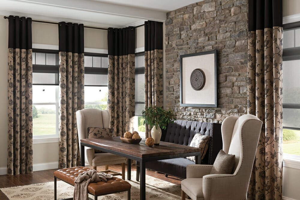 Blackout living room with roller shades and drapes