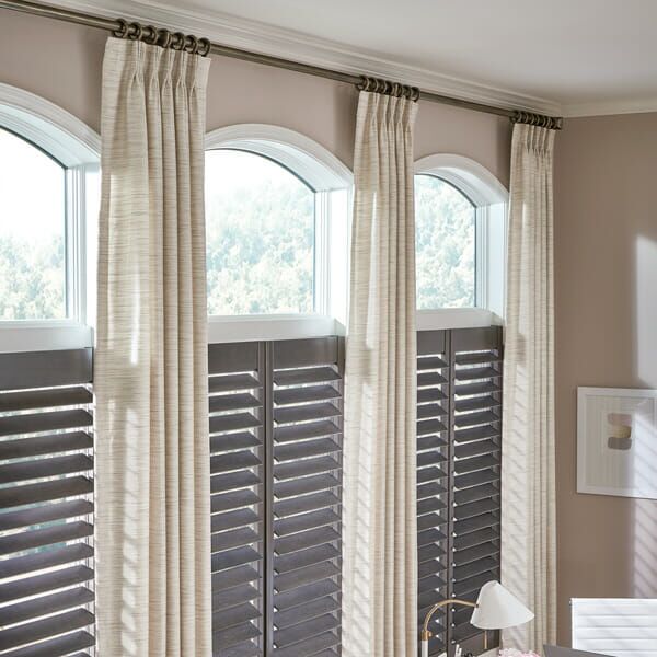 Plantation shutters with drapes