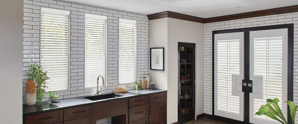 Having a view from your kitchen sink can make prepping food or washing the dishes more pleasurable. Shutters are a low-maintenance alternative to drapery that gives light control and views.