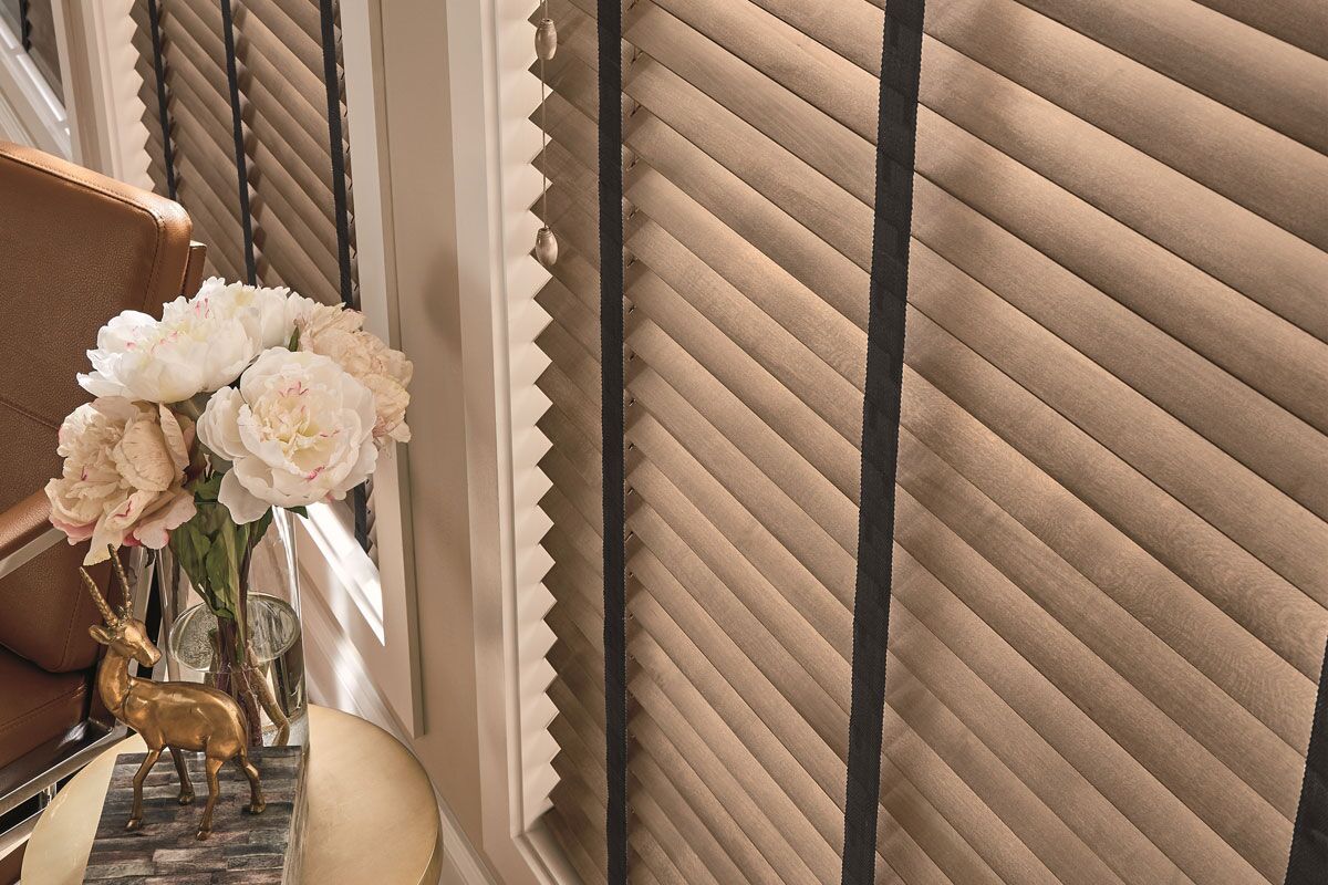 image of brown wooden blinds accented with black cloth tapes