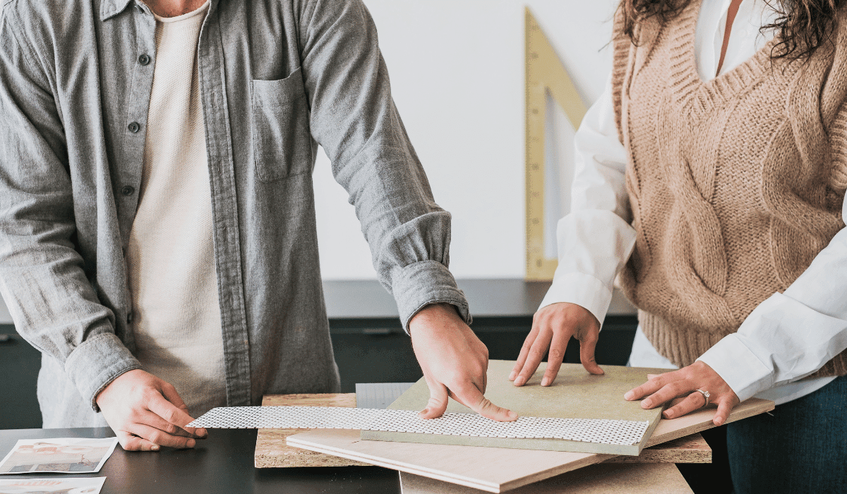 image of man and woman reviewing neutral tone interior decor swatches and samples